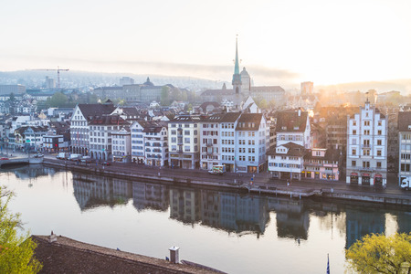 ZURICH, SWITZERLAND - 17TH APRIL 2018: A view of the Zurich skyline from the Lindenhof at sunrise. Architecture can be seen along the Limmatquai street.のeditorial素材
