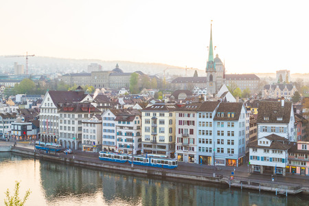 ZURICH, SWITZERLAND - 17TH APRIL 2018: A view of the Zurich skyline from the Lindenhof at sunrise. Architecture and trams can be seen along the Limmatquai street.のeditorial素材