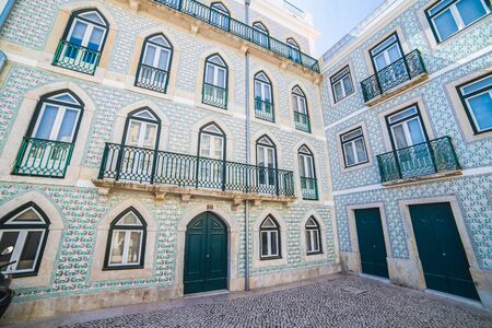 LISBON, PORTUGAL - 12TH AUGUST 2019: The exterior and facades of beautiful buildings in the old Alfama district of Lisbon. Taken during the day.のeditorial素材