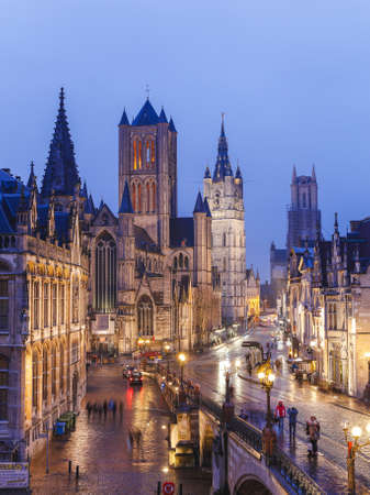 GHENT, BELGIUM - 18TH FEB 2016: Views towards Saint Nicholas' Church at night. People can be seen.のeditorial素材