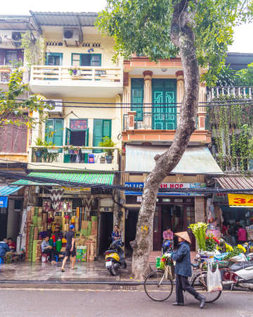 HANOI, VIETNAM - 19TH MARCH 2017: Views along streets in Hanoi Vietnam during the day. The outside of buildings and people can be seen.のeditorial素材