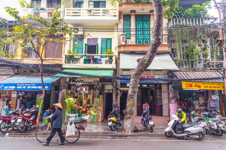 HANOI, VIETNAM - 19TH MARCH 2017: Views along streets in Hanoi Vietnam during the day. The outside of buildings and people can be seen.のeditorial素材