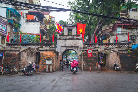 HANOI, VIETNAM - 19TH MARCH 2017: The Quan Chuong City Gate in Hanoi Old Quarter during the day. People can be seen.のeditorial素材