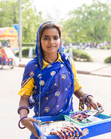 DELHI, INDIA - 19TH MARCH 2016: A lady wearing traditional clothes and selling arts and crafts in...