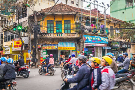 HANOI, VIETNAM - 19TH MARCH 2017: Really busy traffic on roads in central Hanoi, Vietnam during the day. Showing lots of people, scooters and motorbikes.のeditorial素材
