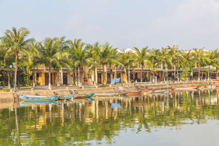HOI AN, VIETNAM - 25TH MARCH 2017: The Hoi An skyline from across the Thu Bon River in Ancient Town Hoi An during the morning. Reflections can be seen in the water.のeditorial素材