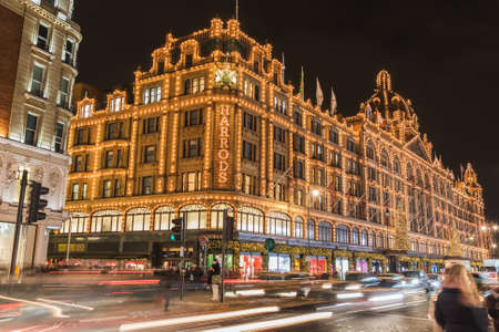 LONDON, UK - 25TH NOV 2018: The outside of Harrods department store in Knightsbridge London at Christmas. Showing large amounts of festive decorations on the building. People can be seen.のeditorial素材