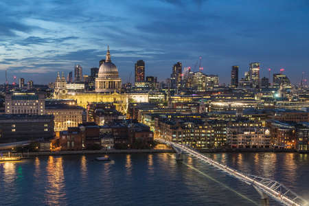 LONDON, UK - 24TH AUGUST 2019: A view towards St Pauls from across the River Thames at night. People can be seen on Millennium Bridgeのeditorial素材