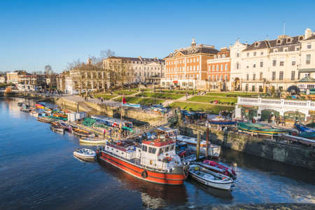 LONDON, UK - 13TH DEC 2017: Views along the waterfront in Richmond. Boats, buildings and people can be seen.のeditorial素材