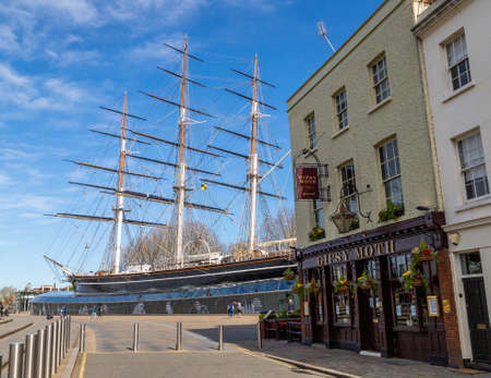 LONDON, UK - 21ST MARCH 2020: The outside of the Cutty Sark museum in Greenwich. Showing the ship, the Gipsy Moth pub and a few people.のeditorial素材