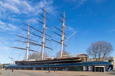 LONDON, UK - 21ST MARCH 2020: The outside of the Cutty Sark museum in Greenwich. Showing the ship and a few people.のeditorial素材