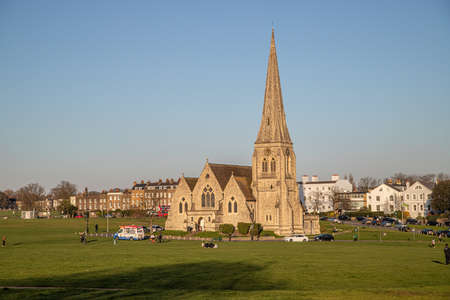 LONDON, UK - 22ND MARCH 2020: The outside of All Saints church in Blackheath. People can be seen outside.のeditorial素材