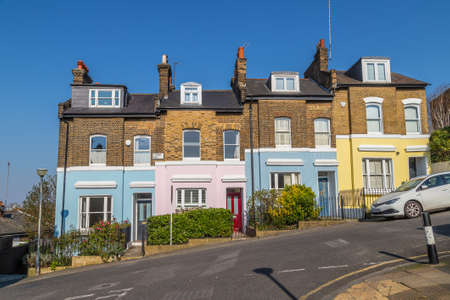 LONDON, UK - 27TH MARCH 2020: Colourful buildings along Point Hill in Greenwich. The exteriors can be seen painted in different colors.のeditorial素材