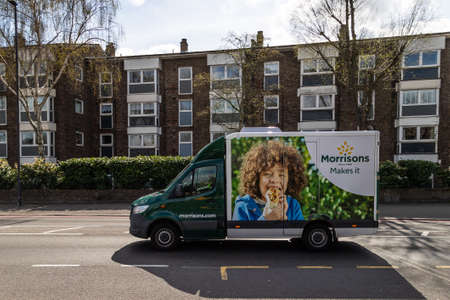 LONDON, UK - 3RD APRIL 2020: A Morrisons delivery truck on a road in London during the day. Morrisons have an online website where people can buy groceries.のeditorial素材
