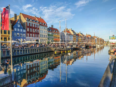 COPENHAGEN, DENMARK - 22ND MAY 2017: Buildings, architecture, boats and reflections along the Nyhavn during the day. Reflections and people can be seen.のeditorial素材