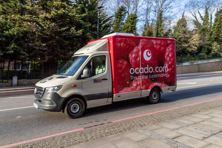 LONDON, UK - 3RD APRIL 2020: An Ocado delivery truck on a road in London during the day. Ocado is an online supermarket where people can buy groceries.のeditorial素材