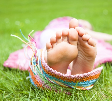 leaxing feets in meadowの写真素材