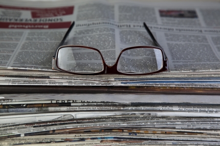 newspaper with reading glassesの写真素材