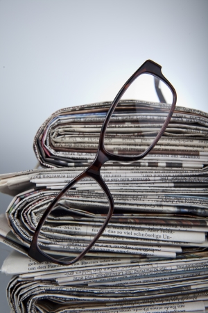 newspaper with reading glassesの写真素材
