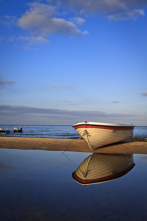 White fisherboat on the sandの写真素材