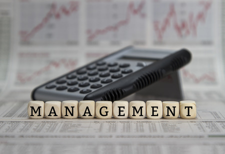 Management word on a business newspaper backgroundの写真素材