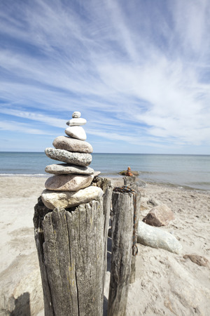 stone looking and building a tower at the beach