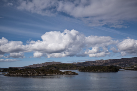 sea with smooth water and dramatic cloudy skyの写真素材
