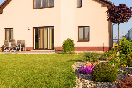 Family house with a lawn and spring garden