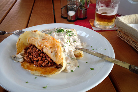 Pancake with minced meat and mushroom cream sauce traditional Ukrainian foodの写真素材