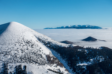 West Tatras mountains from winter ridge of Little Fatra hills National Park. Hill named Stoh on left...