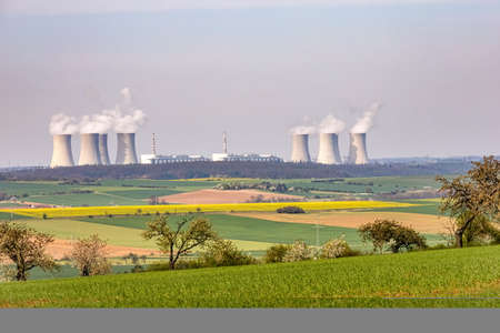 Nuclear power plant on horizon. View through rural spring landscape - Czech Republic, Europe.