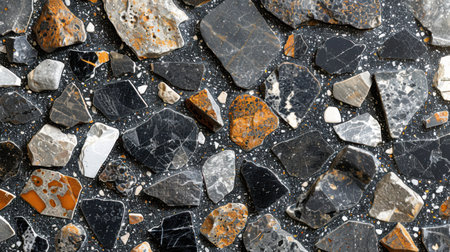 Elegant black, gray, and white terrazzo pattern with scattered stone fragments embedded in seamless polished surfaceの素材