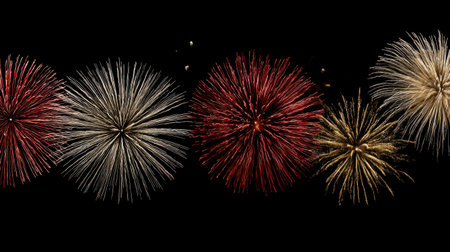 Multiple firework bursts in red, white, and gold symmetrically arranged on a clean black background.の素材