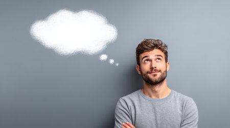 Portrait of a curious thinker gazing into space, floating white cloud text bubble above, neutral gradient background, artistic lighting, no textの素材