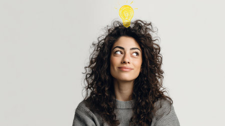 Portrait of a beautiful young woman with curly hair and lightbulb in her head.の素材