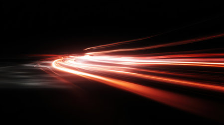 Red motion light trails resembling fast car lights or plasma streams with soft glow and motion blur on dark backgroundの素材