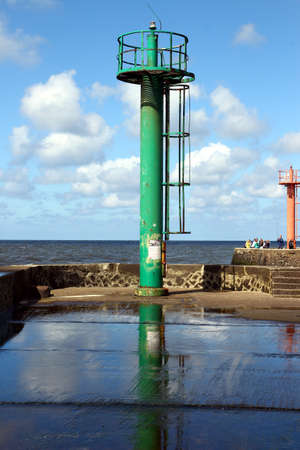 Lighthouse at the entrance to the fishing portの写真素材