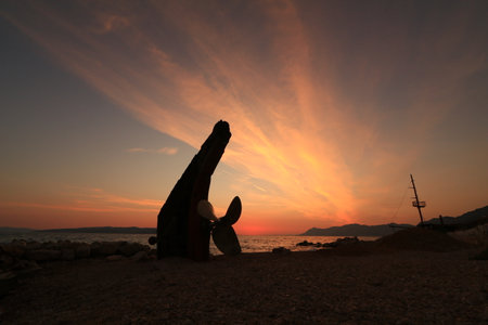 Wreck of a crashed ship against the setting sunの写真素材