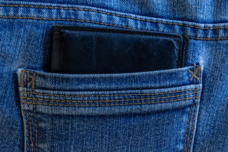 A leather wallet in the back pocket of jeansの写真素材