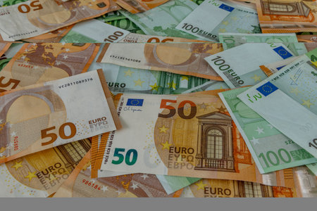 Money scattered on the table one hundred and two hundred Euro banknotesの写真素材