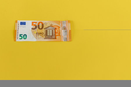 Money scattered on the table one hundred and two hundred Euro banknotesの写真素材