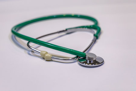Examination with a stethoscope green medical stethoscope on the table for children