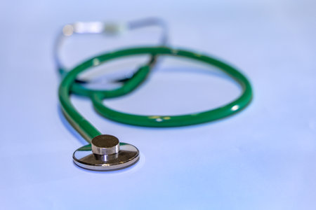 Examination with a stethoscope green medical stethoscope on the table for childrenの写真素材