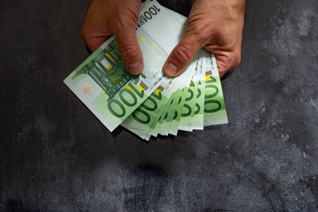 Bankruptcy spending money without limits debts taxes euro in the hands of a man