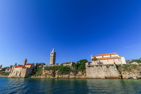 View from the boat over the old town of Rab, historic four church towers, symbol of the city Croatiaの写真素材