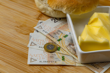 Increase in food prices in Poland, bread, butter on a cutting board, tomatoes, sausage, VAT on food Poland moneyの写真素材