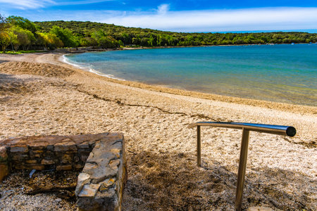 Access to the beach for disabled people is provided by a handrail and a ramp for wheelchairs Croatia Rovinjの写真素材