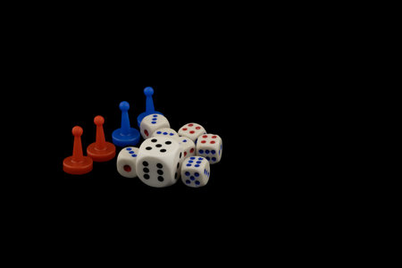 Colorful game pieces and dice on black background relaxing gambling game with diceの写真素材