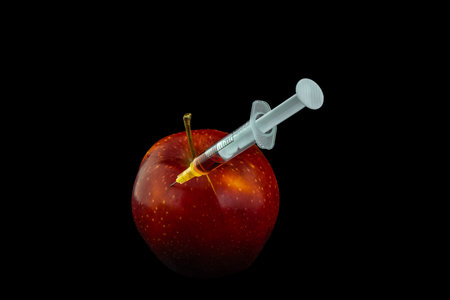 Injecting antibiotics into food genetically modified food GMP red apple grown artificiallyの写真素材