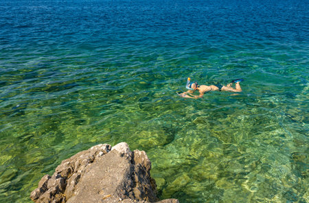 A woman is snorkeling in a swimming mask Croatiaの写真素材
